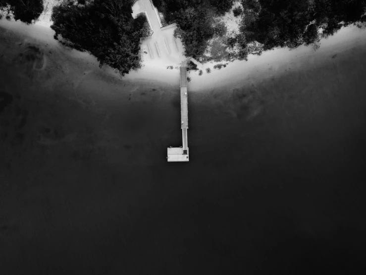 a black and white photo of a road, a black and white photo, unsplash contest winner, minimalism, boat dock, satellite view, body in water, drone photograpghy