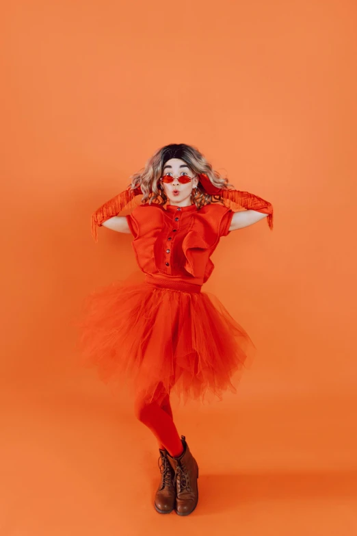 a woman in a red dress posing for a picture, an album cover, pexels, conceptual art, fuzzy orange puppet, wearing a tutu, drag, pose 4 of 1 6