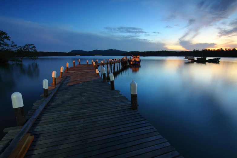 a dock that is next to a body of water, pexels contest winner, soft evening lighting, blue, vray, endless lake