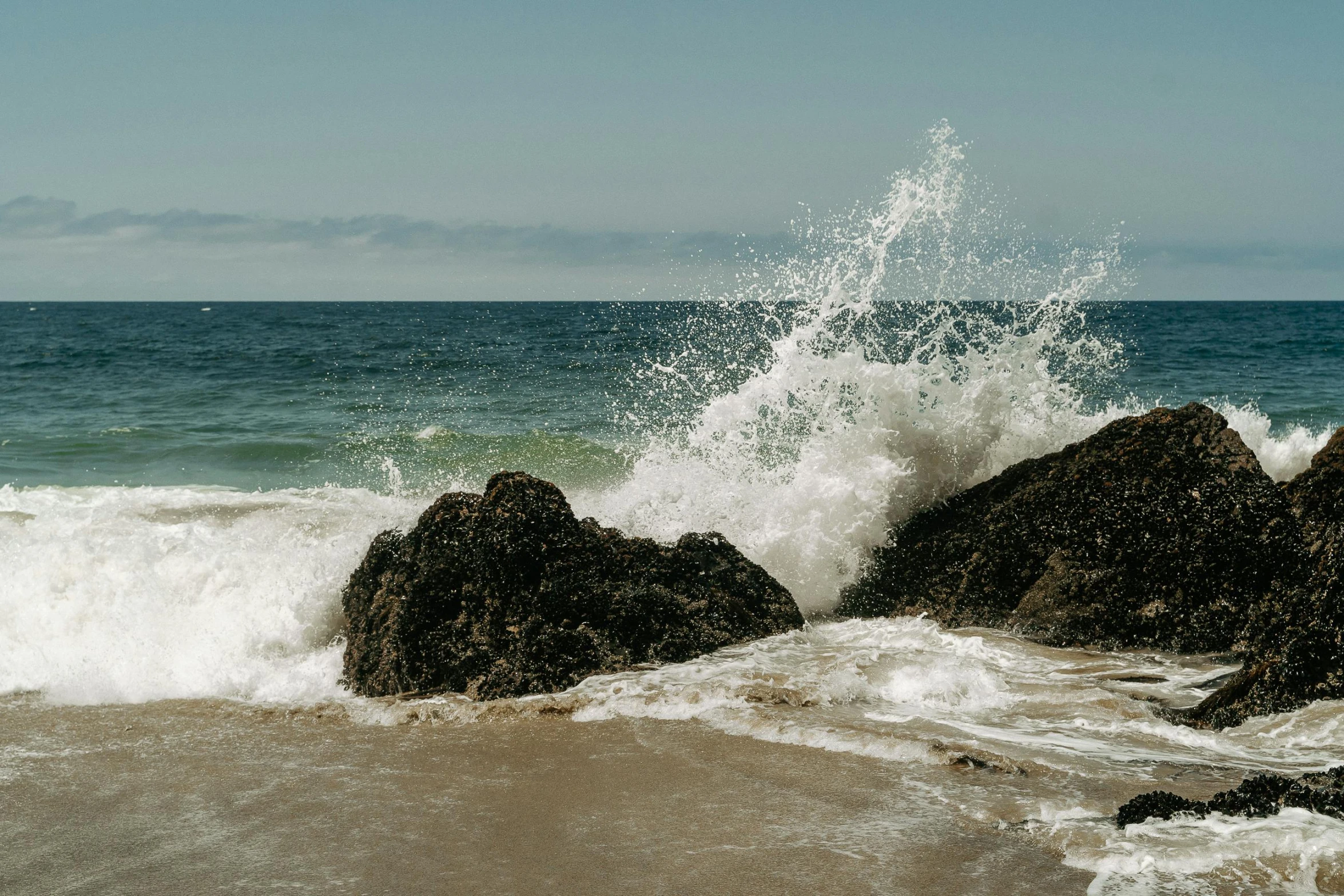 a man riding a surfboard on top of a wave covered beach, pexels contest winner, waves crashing at rocks, hollister ranch, as well as scratches, ignant