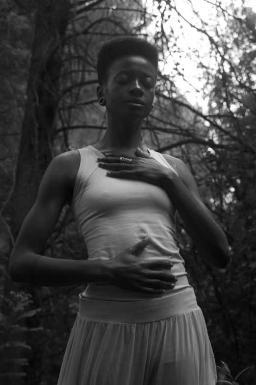 a black and white photo of a woman in the woods, inspired by Carrie Mae Weems, scales on her chest, medium format. soft light, african american young woman, adut akech