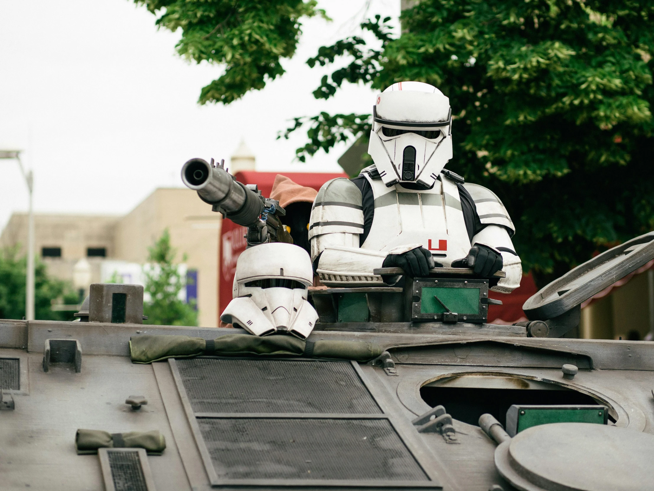 a star wars stormtrooper sitting on top of a tank, a photo, unsplash, les automatistes, cosplay photo, medium shot of two characters, military parade, decipticon armor plating