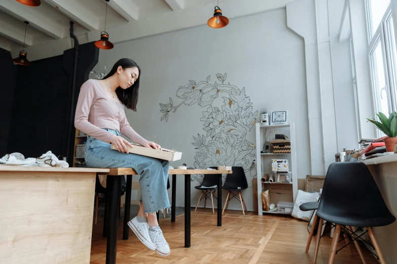 a woman sitting on top of a wooden table, a drawing, by Jang Seung-eop, pexels contest winner, working in an office, full body photo, background image, holding notebook