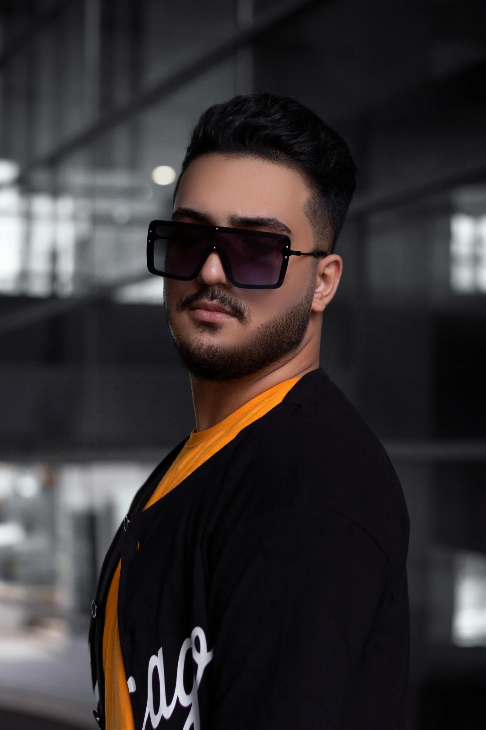 a man wearing sunglasses standing in front of a building, an album cover, inspired by Nabil Kanso, trending on pexels, les nabis, plus size, headshot profile picture, young male, square