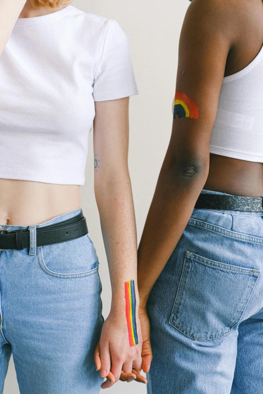 a couple of women standing next to each other, trending on pexels, feminist art, rainbow accents, bare midriff, 👅 👅, stick and poke