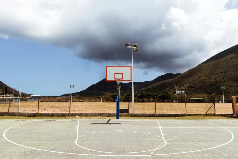 a basketball court with mountains in the background, by Matthias Stom, unsplash contest winner, hyperrealism, reunion island, in a square, unhappy, hammershøi