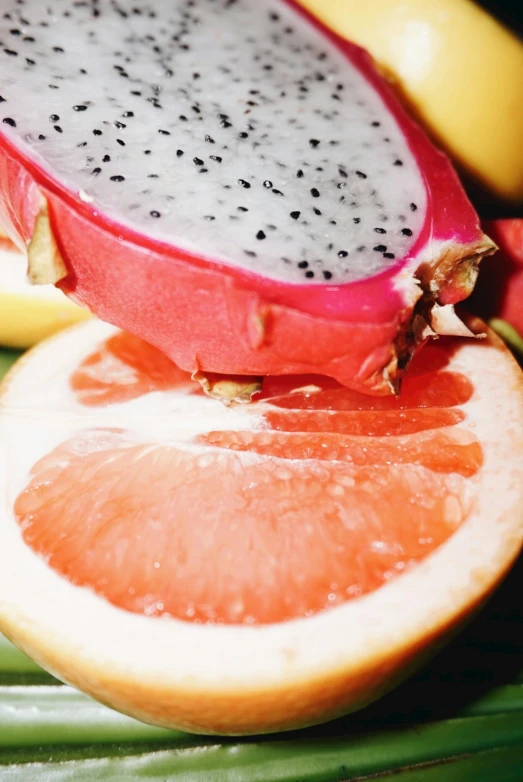 a close up of a dragon fruit cut in half, sliced grapefruit, multiple stories, william open, mix