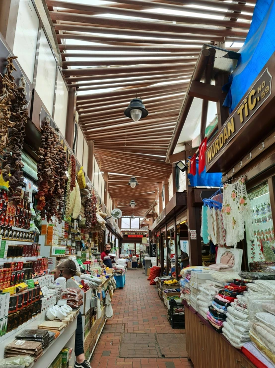 a store filled with lots of different types of food, a picture, peaked wooden roofs, thumbnail, walkway, aykut aydogdu