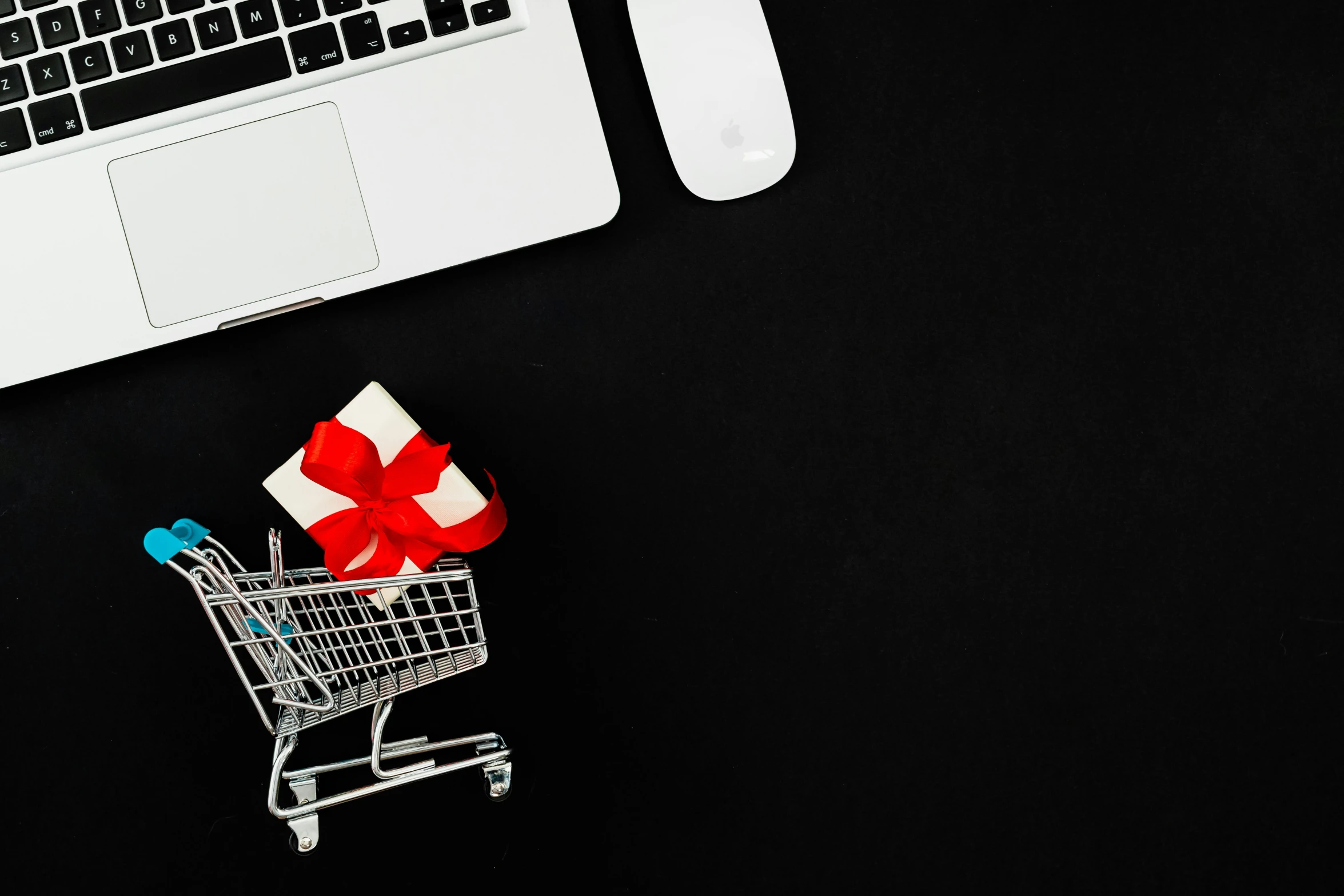 a laptop computer sitting on top of a desk next to a shopping cart, giving gifts to people, thumbnail, dark. no text, 000 — википедия