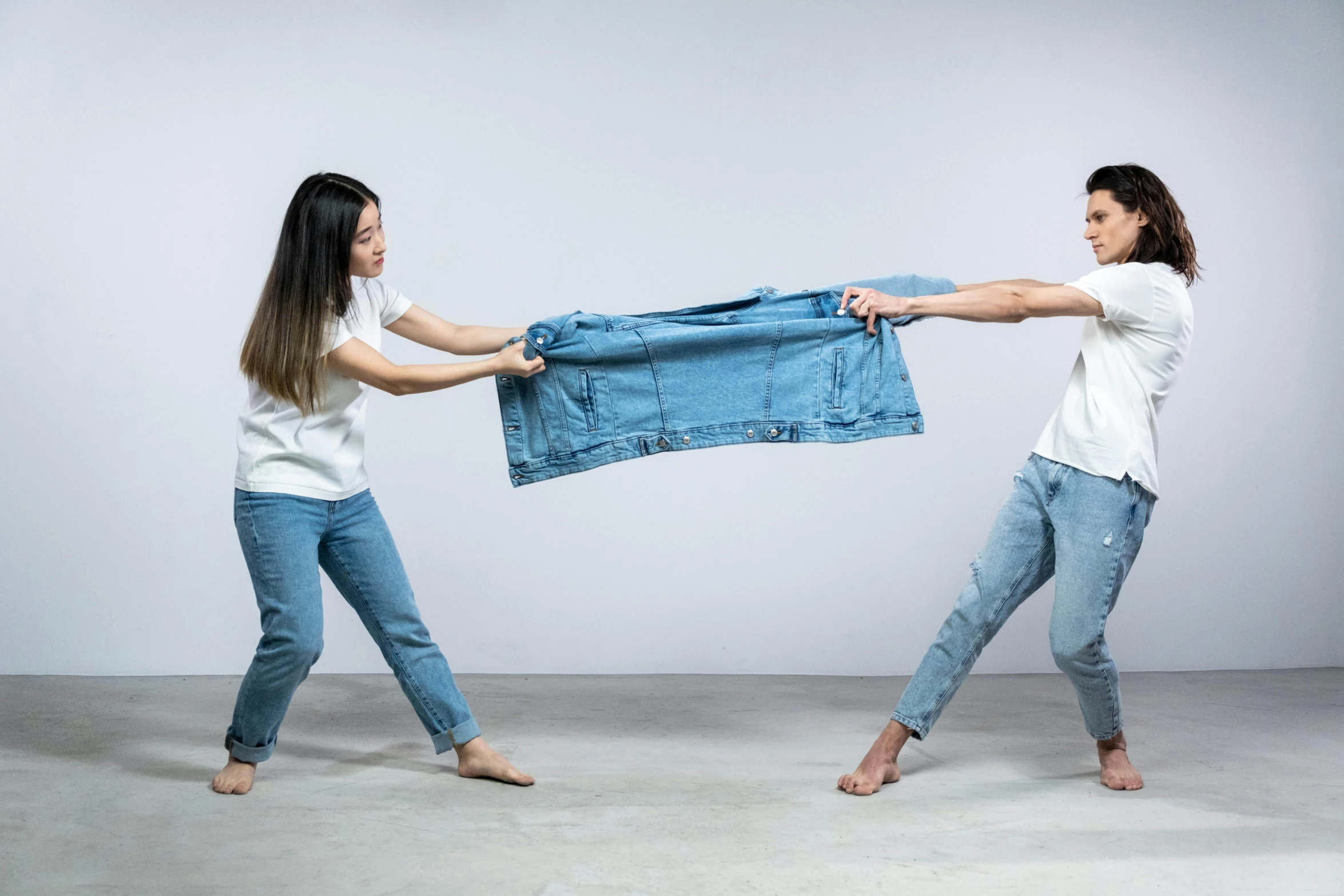 two women fighting over a denim jacket, pexels contest winner, conceptual art, wearing pants and a t-shirt, man and woman, slightly minimal, keng lye