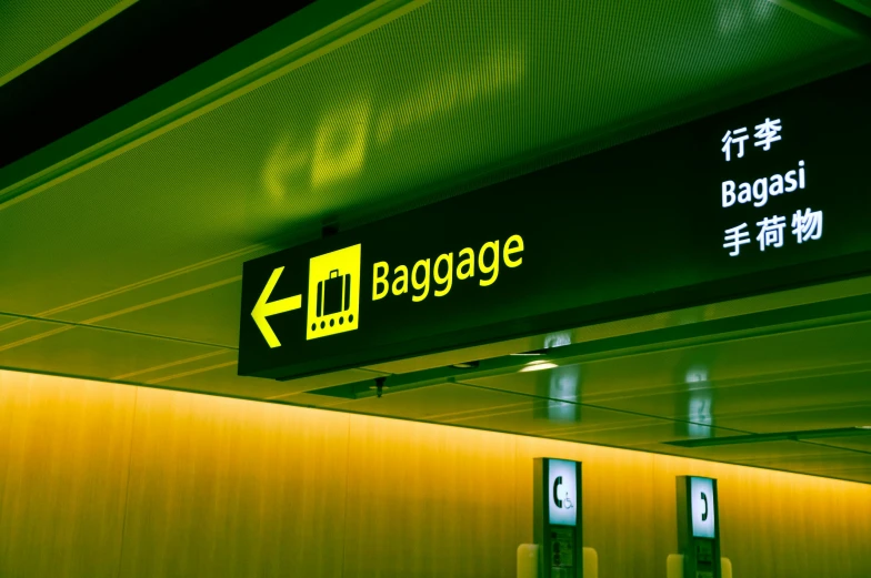 a close up of a sign at an airport, a picture, by Jessie Algie, shutterstock, bags, green ambient light, square, yellow lighting from right