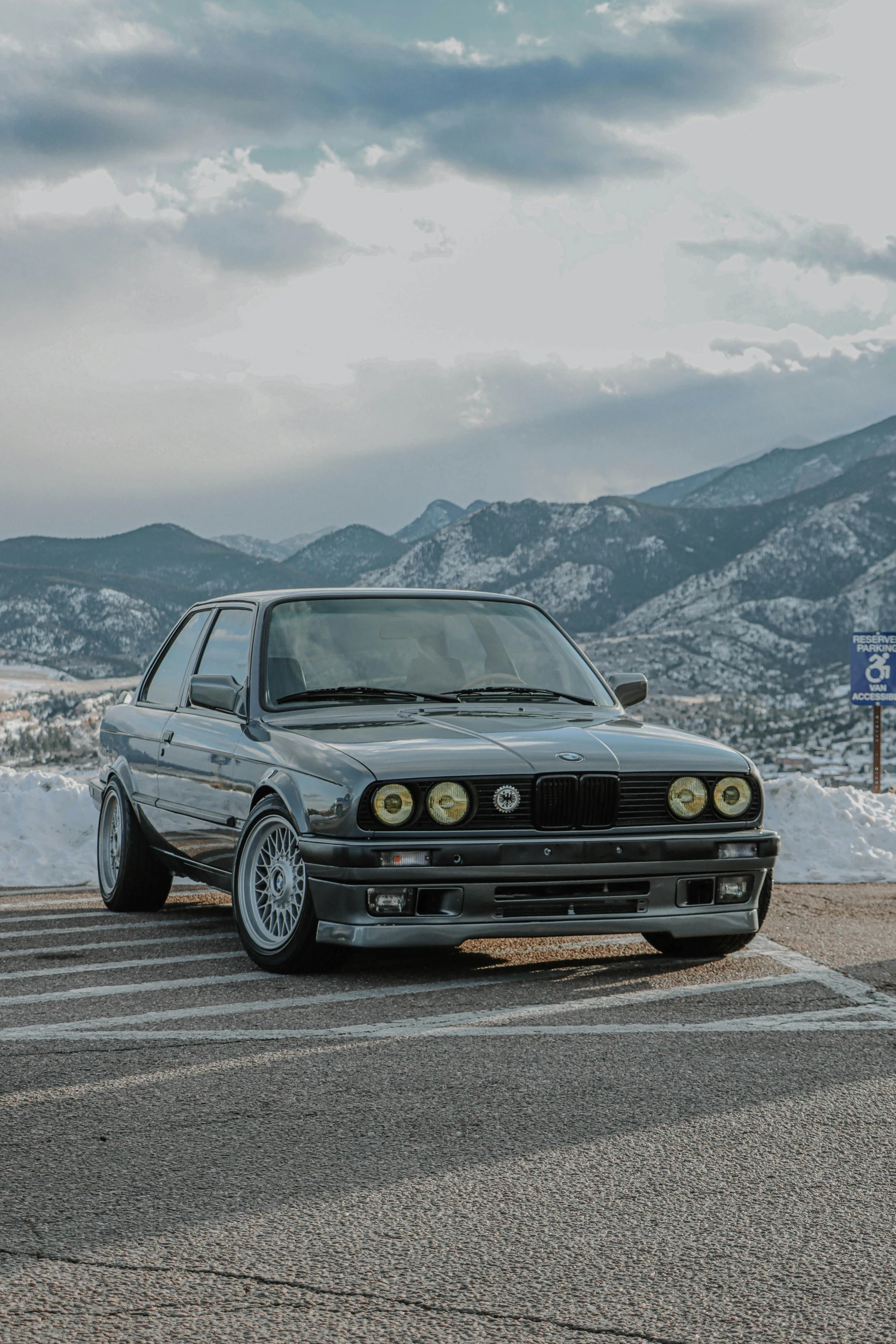 a car that is sitting on the side of the road, by Drew Tucker, unsplash contest winner, renaissance, bmw e 3 0, with mountains as background, january 20th, regular build