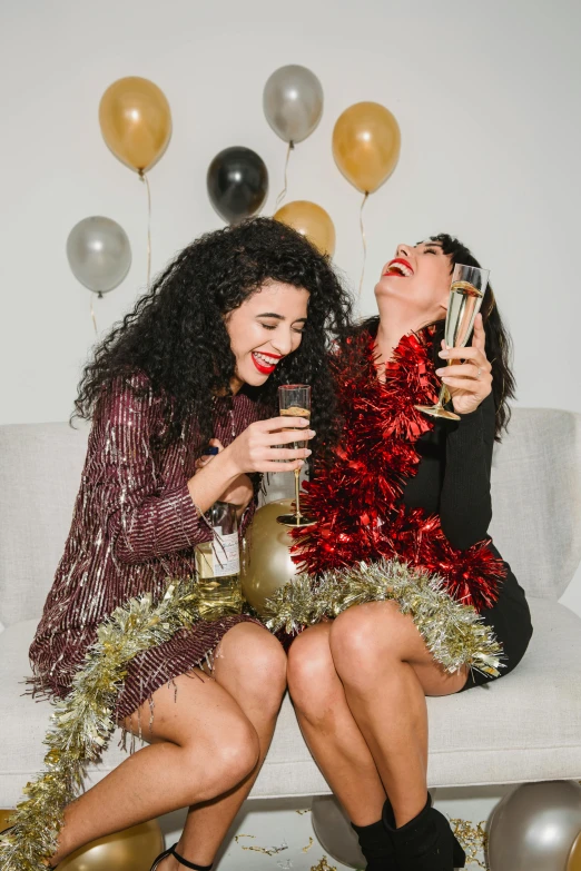 a couple of women sitting on top of a couch, new years eve, profile image, laughing maniacally, glitter accents on figure