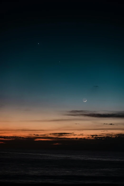 the moon is setting in the sky over the ocean, by Jesper Knudsen, unsplash, stars and paisley filled sky, break of dawn on venus, 3 moons, minimalist photo