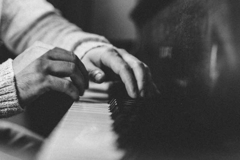 a close up of a person playing a piano, a black and white photo, by Matija Jama, pexels, unknown artist, detailed », valeriy vegera, by greg rutkowski