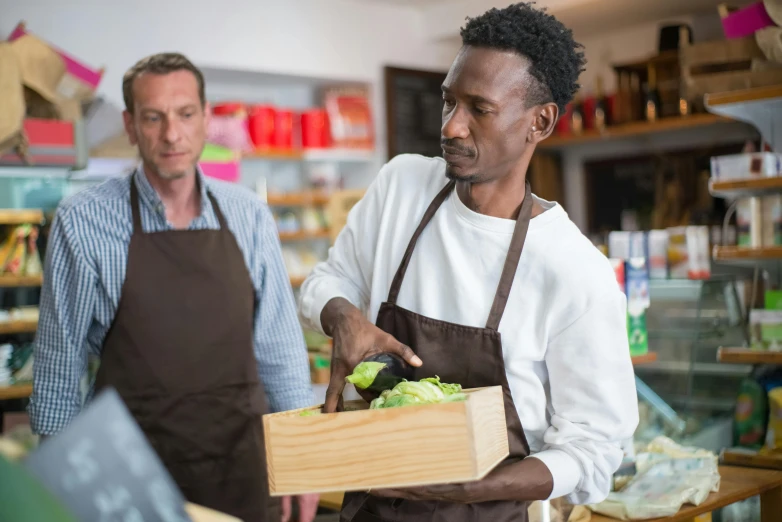 a couple of men standing next to each other in a store, pexels contest winner, renaissance, delivering parsel box, black man, getting groceries, lachlan bailey