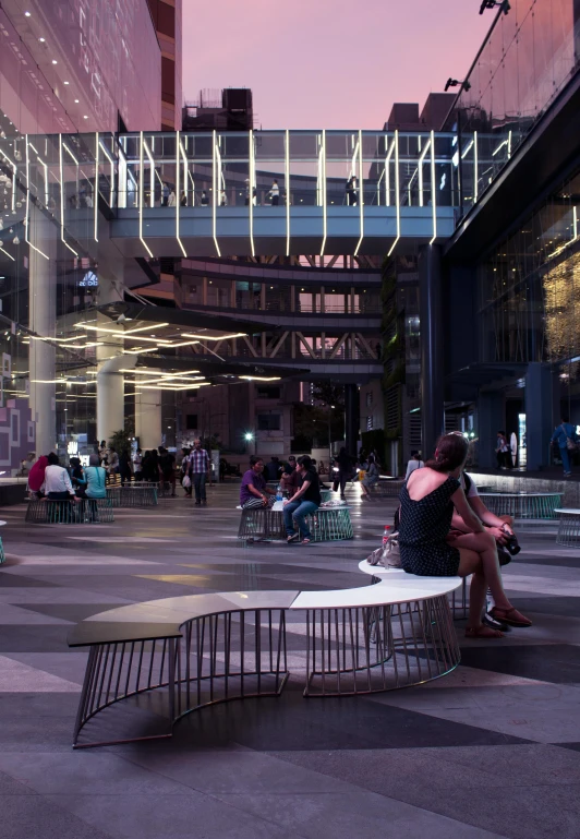 a couple of people that are sitting on a bench, a digital rendering, trending on unsplash, conceptual art, abandoned mall at night, bangkok townsquare, in a open-space working space, intricate ”