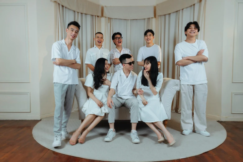 a group of people sitting on top of a couch, an album cover, inspired by Gang Hui-an, pexels contest winner, white uniform, singapore, group of seven, cutecore