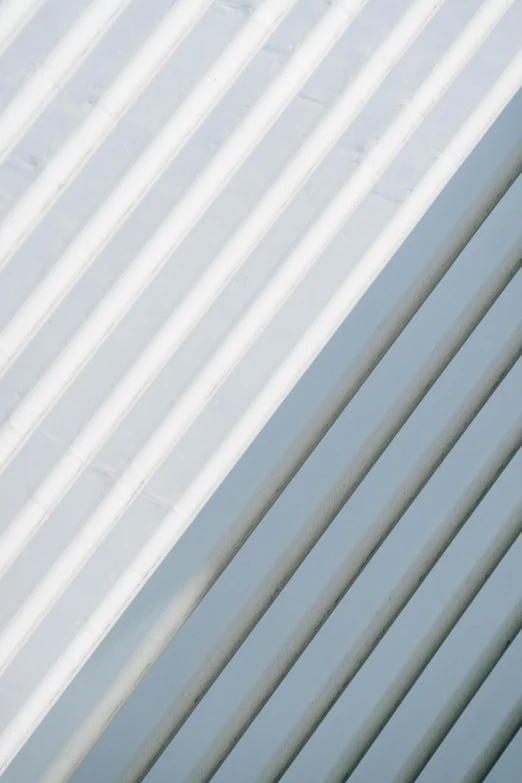 a red fire hydrant sitting on the side of a building, inspired by Agnes Martin, unsplash, modernism, gradient white to silver, pale cyan and grey fabric, a pair of ribbed, roofs