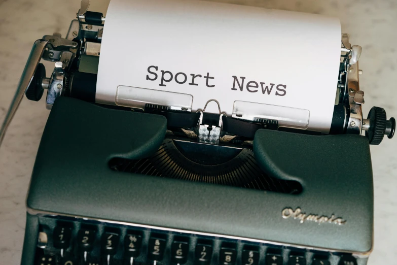 a close up of a typewriter with a paper on it, by Carey Morris, pexels contest winner, happening, sports logo, news report, sporty physique, large text