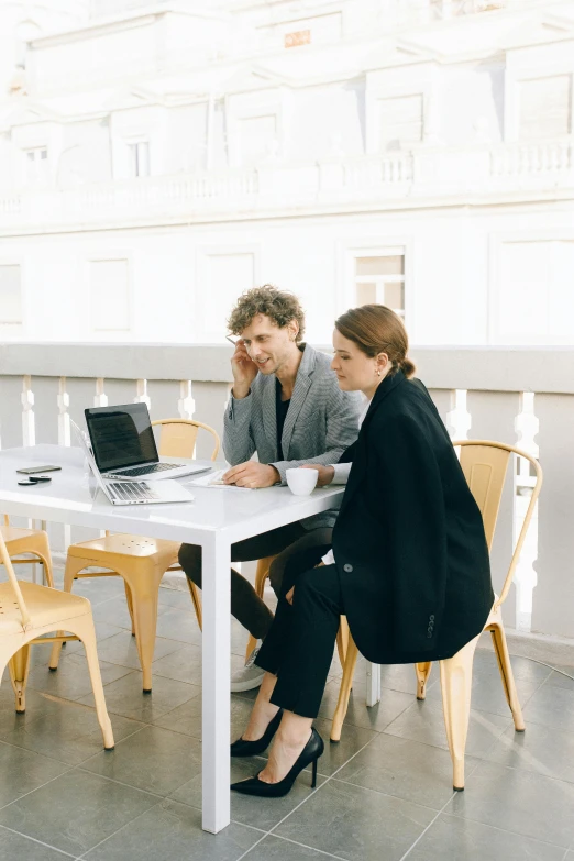 a group of people sitting around a white table, in front of a computer, profile image, tailored clothing, al fresco