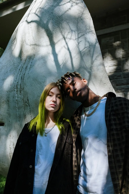 a man and a woman standing next to each other, inspired by Elsa Bleda, trending on pexels, renaissance, bright green hair, yzy gap, riyahd cassiem, press shot