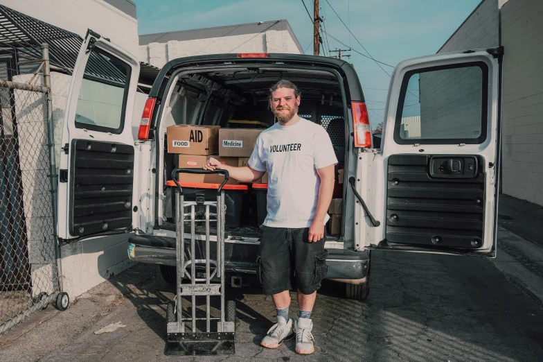 a man that is standing in front of a van, full of things, adi meyers, full product shot, avatar image