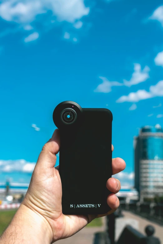 a person taking a picture with their cell phone, pexels contest winner, photorealism, inverted fisheye lens!!!, blue sky, petzval lens, medium long shot