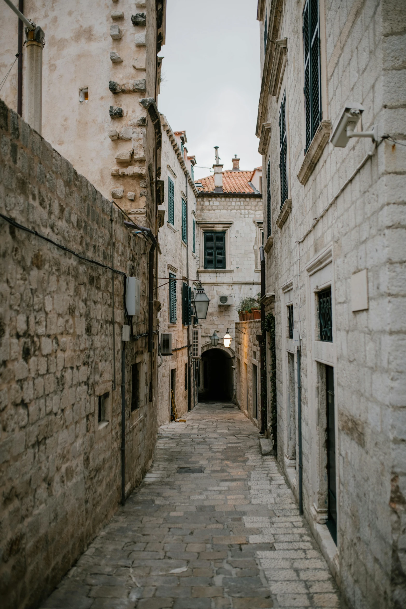 a narrow alley in the old town of dubna, croatia, unsplash contest winner, dubrovnik, dry archways and spires, square, taken in the early 2020s