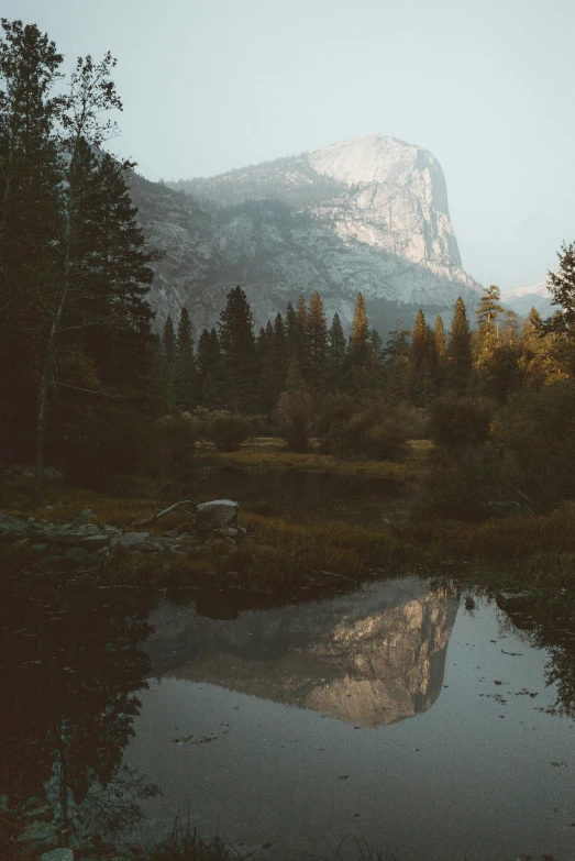 a body of water with a mountain in the background, yosemite, forest outside, cinematic morning light, multiple stories