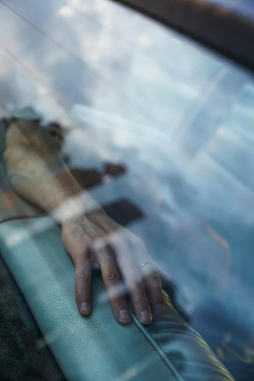 a person's hand sticking out of a car window, by Adam Chmielowski, happening, asleep, translucent, ap art, sara ali