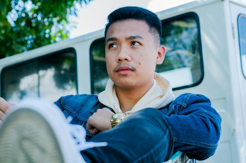 a man standing in front of a white van, inspired by Eddie Mendoza, pexels contest winner, looking to the side off camera, sitting down, male teenager, ngai victo and dougherty patrick