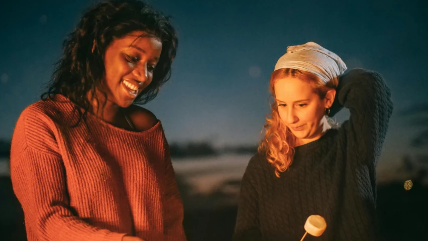 a couple of women standing next to each other, trending on unsplash, renaissance, torchlit, picnic, warm coloured, production photo