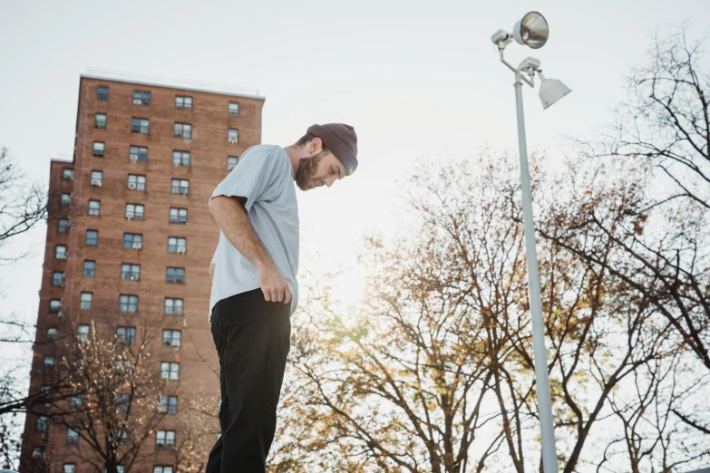 a man riding a skateboard up the side of a ramp, a portrait, by Andrew Stevovich, unsplash, realism, under street lamp, men look up at the sky, parkour, ignant