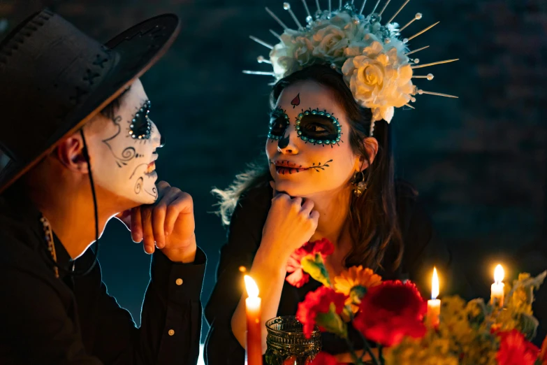 a couple of people sitting at a table with candles, pexels contest winner, vanitas, dia de los muertos makeup, headpiece headpiece headpiece, promo image, glowing-eyes-and-mouth