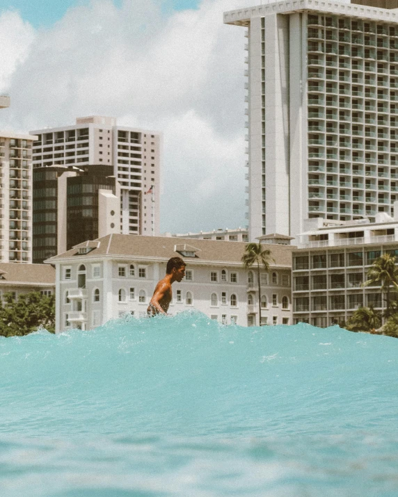 a man riding a wave on top of a surfboard, buildings in the distance, posing in waikiki, an epic non - binary model, billboard image