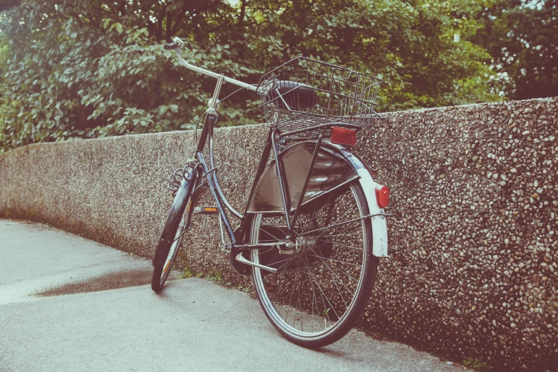 a bicycle that is leaning against a wall, on the sidewalk, profile image, vintage photo, instagram photo