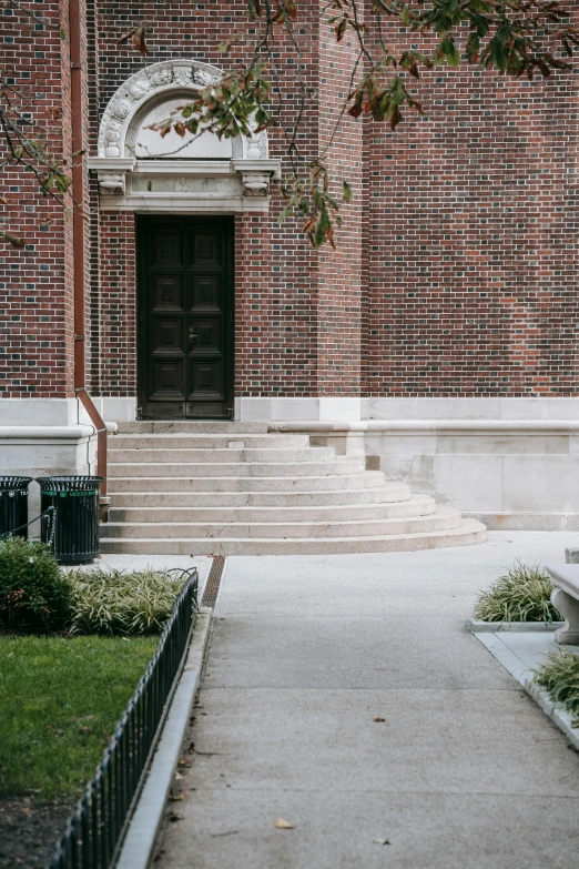 a red fire hydrant sitting in front of a brick building, a statue, american barbizon school, steps leading down, stone pews, 1 staircase, while marble