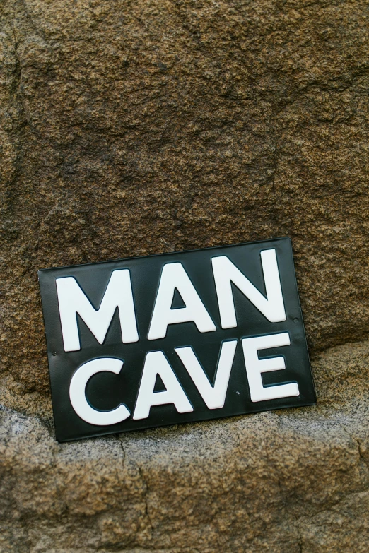 a man cave sign sitting on top of a rock, by Ian Hamilton Finlay, reddit, 84mm), small man, multi-part, shaved