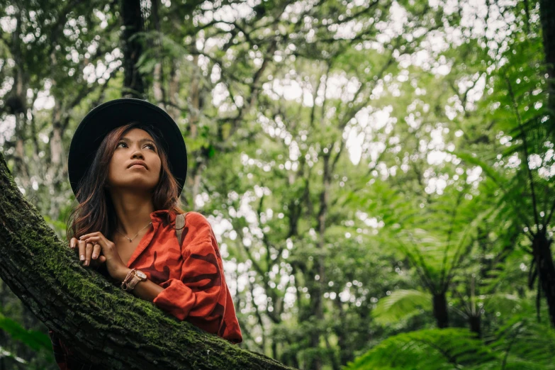 a woman in a hat sitting on a tree branch, trending on unsplash, sumatraism, green and brown clothes, avatar image