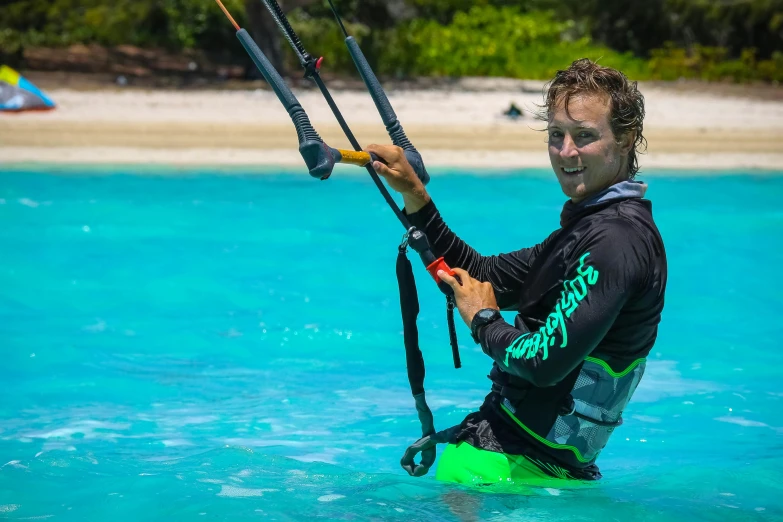 a man riding a kite board on top of a body of water, turquoise water, avatar image