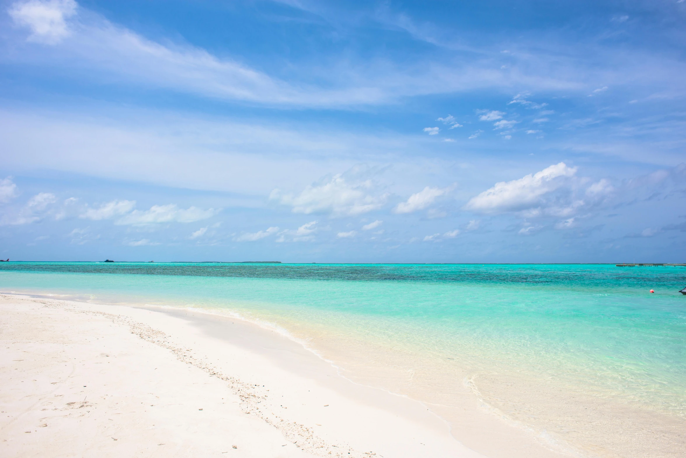 a large body of water next to a sandy beach, by Sophia Beale, pexels contest winner, hurufiyya, white cyan, studio photo, john pawson, beautiful tropical island beach