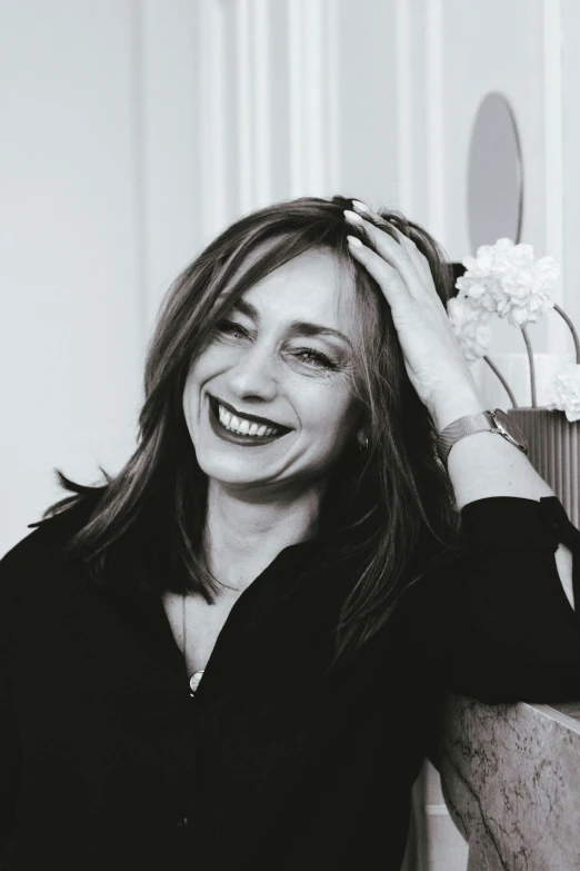 a black and white photo of a woman smiling, inspired by Eva Gonzalès, giorgia meloni, hair down, delightful surroundings, as cristina kirchner