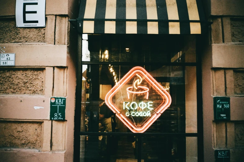 a neon sign that is on the side of a building, pexels contest winner, coffee shop, klee, profile image, exiting store