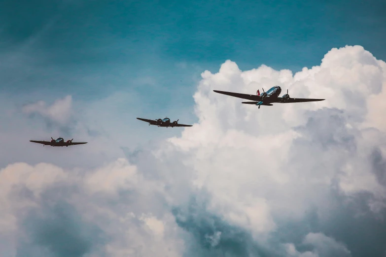 a couple of airplanes flying through a cloudy sky, a colorized photo, by Jay Hambidge, pexels contest winner, second world war, three birds flying around it, avatar image, dunkirk