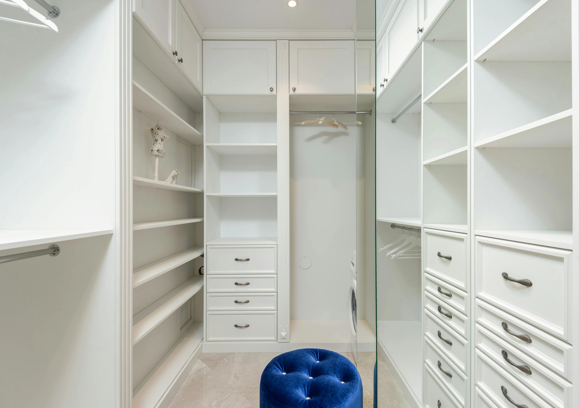 a walk in closet with a blue stool, featured on reddit, pristine clean design, colour corrected, cabinets, profile image