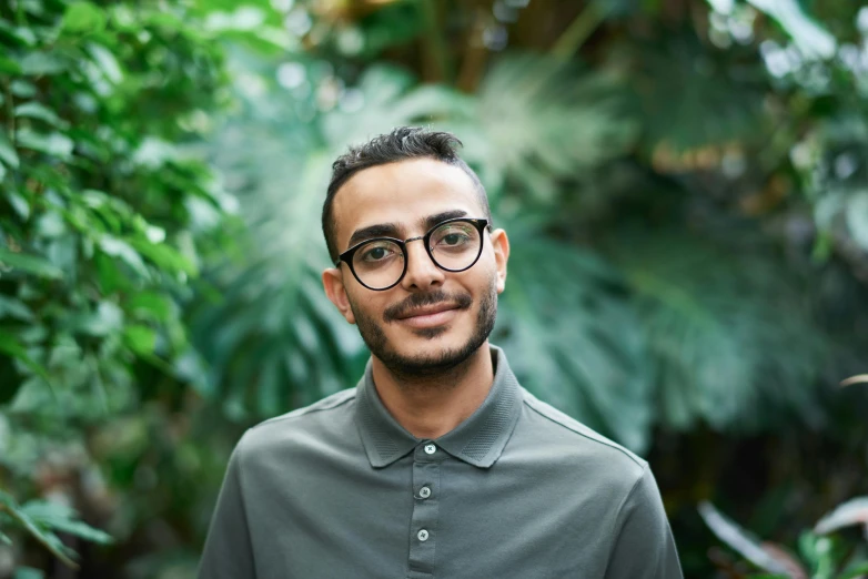 a close up of a person wearing glasses, inspired by Ahmed Yacoubi, lush surroundings, professional profile picture, aged 2 5, portrait”