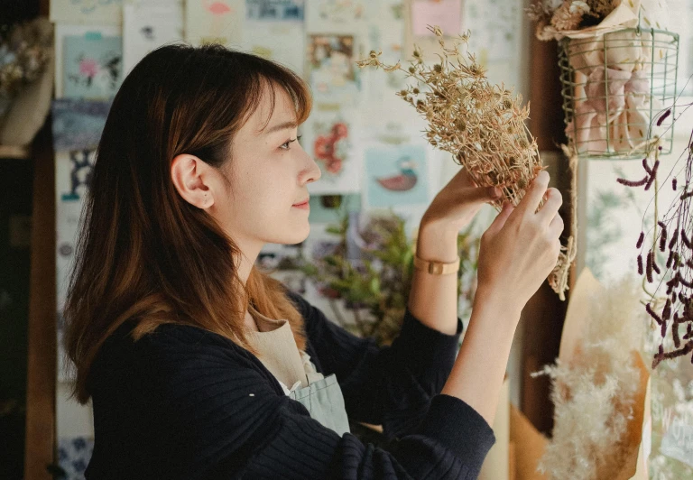 a woman holding a bunch of dried flowers, a picture, pexels contest winner, arts and crafts movement, people at work, japanese collection product, profile pic, decoration