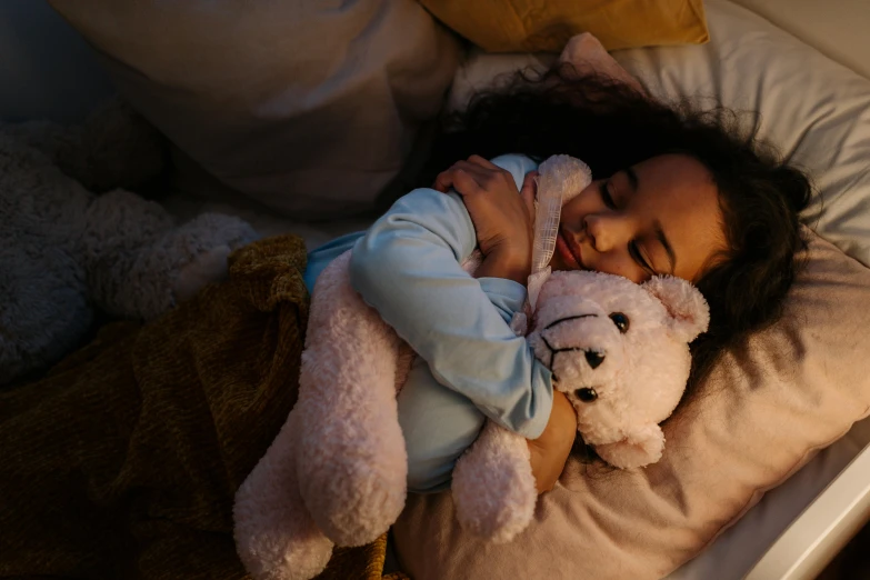 a little girl laying in bed with a teddy bear, pexels contest winner, hurufiyya, calm night. over shoulder shot, hugging each other, asleep, unedited