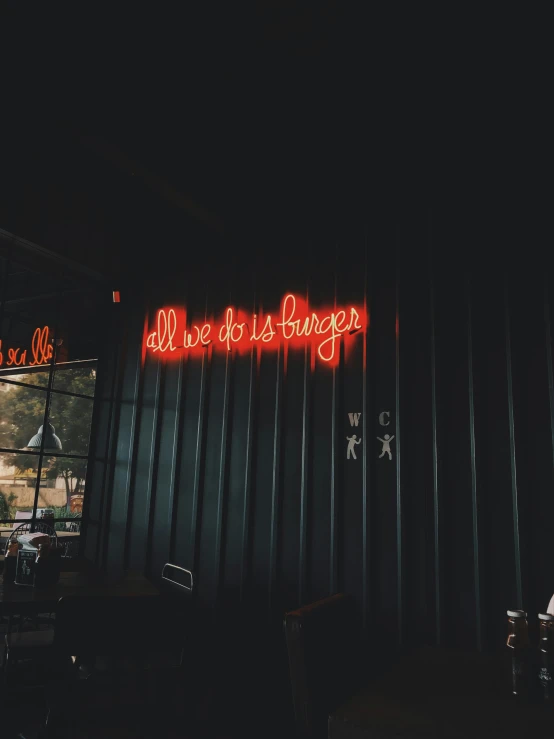 a neon sign hanging from the side of a building, standing in a restaurant, trending on vsco, profile image